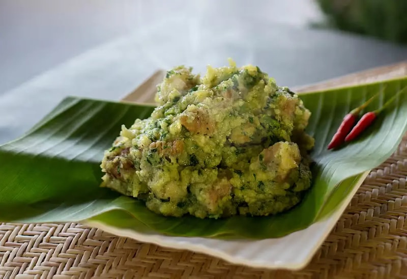 A plate of local Khasi cuisine served in a simple, inviting setting at a tourist lodge